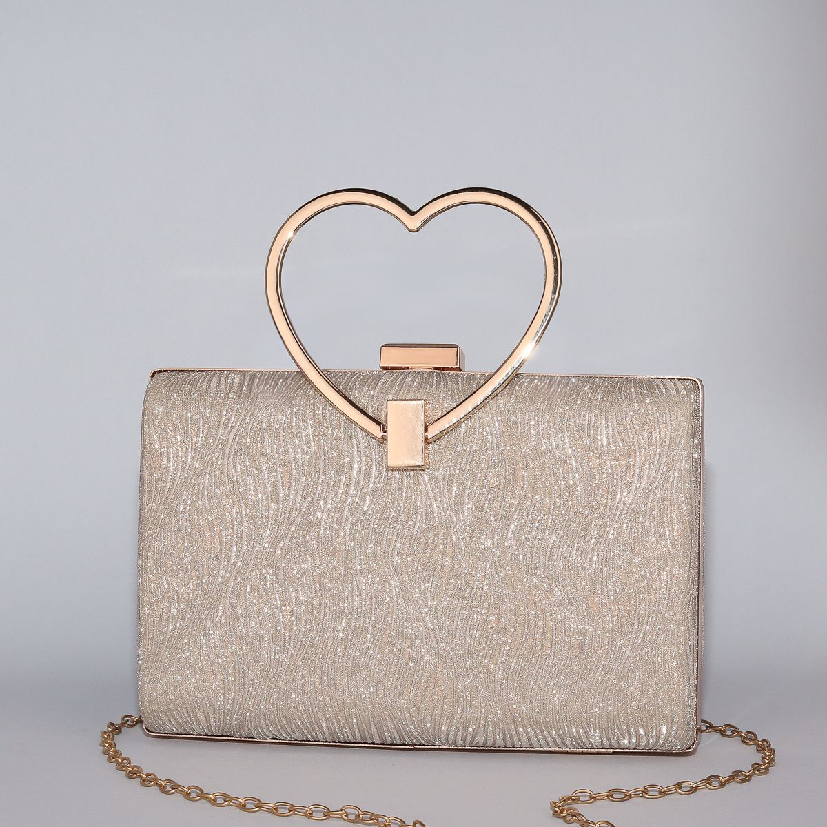 Wavy Pattern Shimmering Clutch with Heart-Shaped Handle